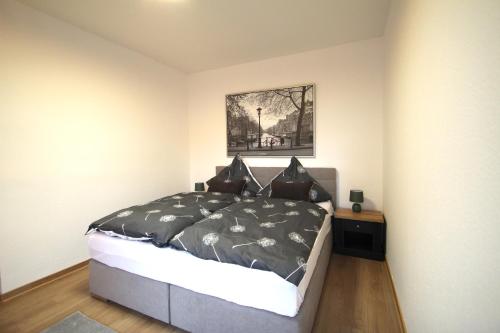 a bedroom with a bed and a picture on the wall at Apartment im Zentrum von Bad Schwartau in Bad Schwartau