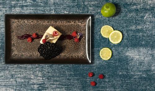 a plate of food with fruit on a table at Mövenpick Hotel Gammarth Tunis in Gammarth
