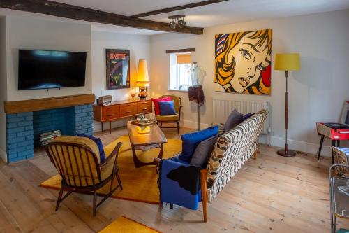 a living room with a couch and a fireplace at 1960s Inspired City Centre Apartment for 4 with Parking in Norwich