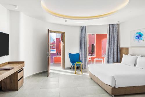 a bedroom with a bed and a flat screen tv at Pickalbatros Laguna Club Resort Sharm El Sheikh in Sharm El Sheikh