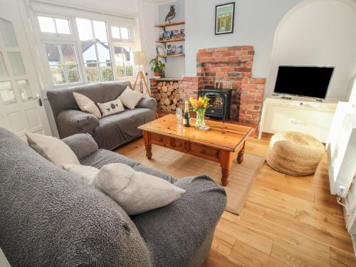 a living room with a couch and a fireplace at 8 New Houses in Wrexham