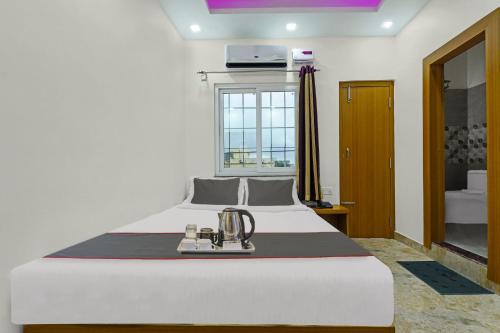 a bedroom with a large white bed and a window at Hotel D N Grand in Rānchī