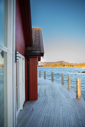 a building on a dock next to a body of water at Norsk Havbrukssenter - Rorbuer in Brønnøysund