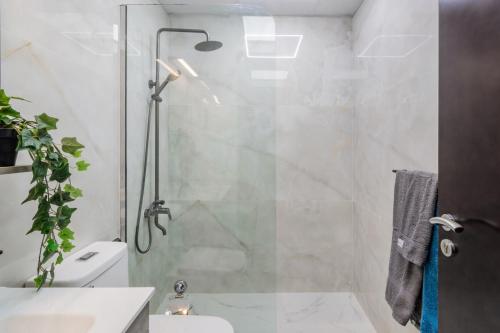 a bathroom with a shower with a glass door at Premium 1BHK near Metro station Dubai Marina & JBR in Dubai