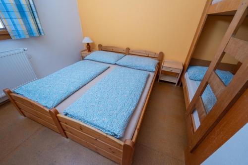 a bedroom with two bunk beds in a room at Apartmány U Gášků in Velké Karlovice