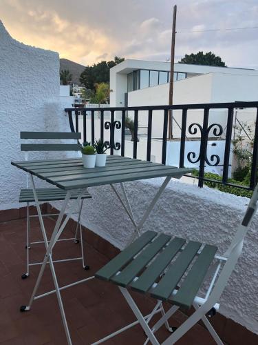 a picnic table and a chair on a balcony at ENDAGORA in Níjar