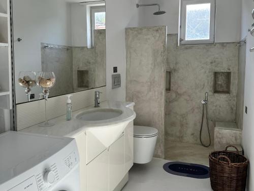 a bathroom with a sink and a toilet and a shower at Louisa’s View in Hydra