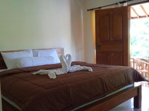 Postel nebo postele na pokoji v ubytování Yeh Ning Guest House