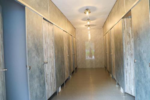 a hallway with wooden lockers in a building at Mộc Châu Island - Lune Camping in Mộc Châu