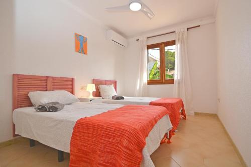 a bedroom with two beds and a window at Boreal House in Alcudia