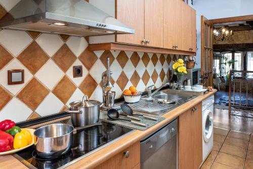 a kitchen with pots and pans on the counter at Abad casa Siguenza 250m2 vivienda y exterior in Sigüenza