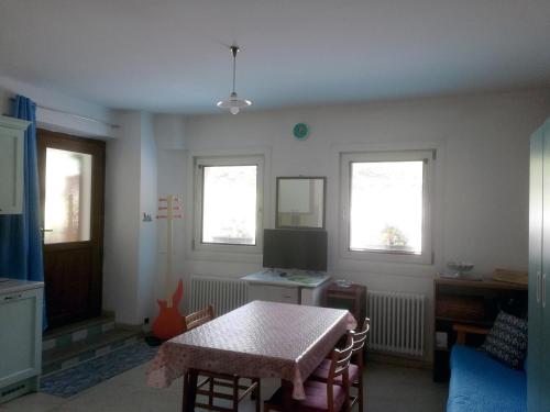 a living room with a table and a television at Appartamenti Codàn in San Vito di Cadore