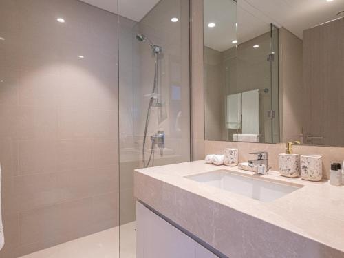 a bathroom with a sink and a shower at MH- Act - Burj View 3BHK-REF4008 in Dubai