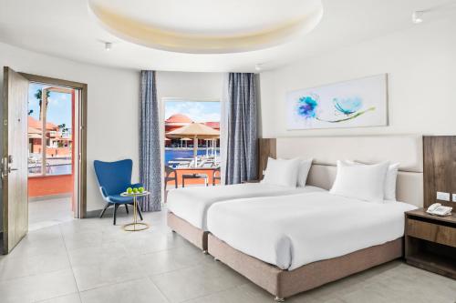 a hotel room with a bed and a dining area at Pickalbatros Laguna Club Resort Sharm El Sheikh in Sharm El Sheikh