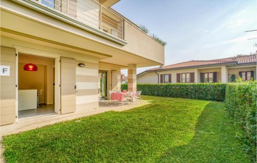a backyard of a house with green grass at Beautiful Home In Puegnago Sul Garda in Raffa