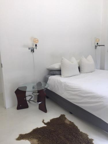 a bedroom with two beds and a glass table at Leisure Isle 2 bedroom home with essential power. in Knysna