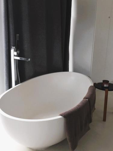 a white bath tub sitting in a bathroom at Leisure Isle 2 bedroom home with essential power. in Knysna