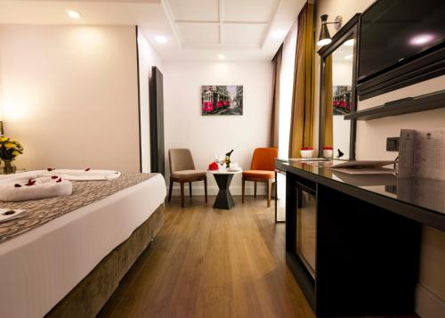 a hotel room with a bed and a kitchen at Antusa Design Hotel & Spa in Istanbul