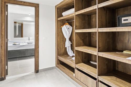 a bathroom with wooden shelves and a mirror at Pickalbatros Laguna Club Resort Sharm El Sheikh in Sharm El Sheikh