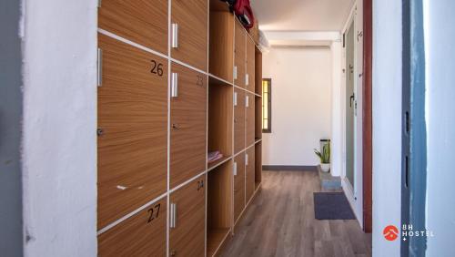 a hallway with wooden lockers in a building at 8h-hostel in Ho Chi Minh City