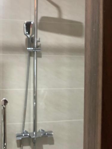 a shower in a bathroom with a glass door at Bờ Biển Vàng Resort in Ke Ga
