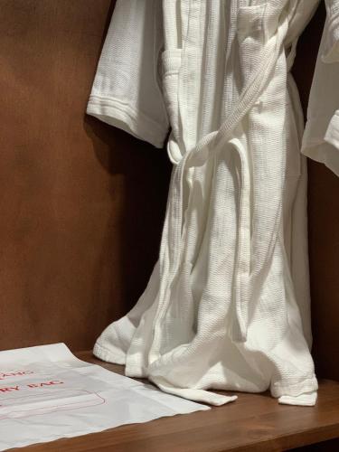 a white wedding dress is hanging on a shelf at Bờ Biển Vàng Resort in Ke Ga