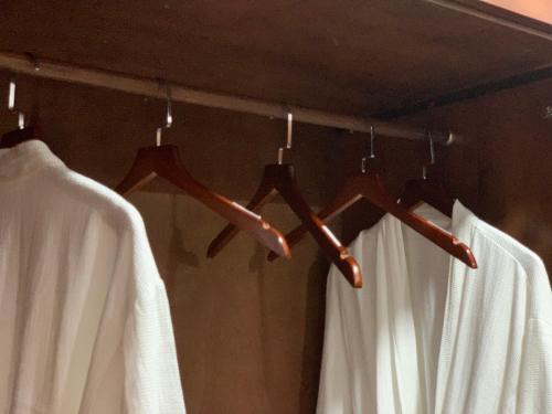 a group of hangers in a bathroom with white curtains at Bờ Biển Vàng Resort in Ke Ga