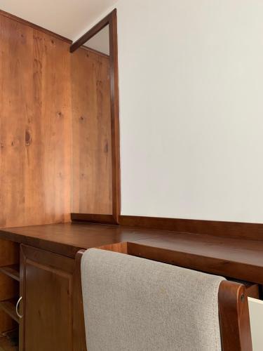a wooden desk with a chair in a room at Bờ Biển Vàng Resort in Ke Ga