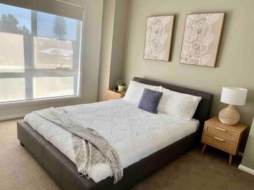 a bedroom with a large bed and a window at Sofia’s Place in Aldinga Beach