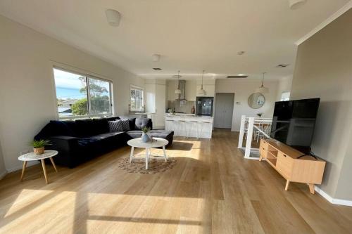 a living room with a couch and a table at Sofia’s Place in Aldinga Beach