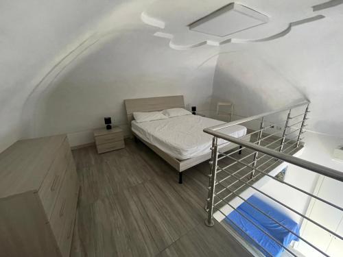 a small bedroom with a bed and a staircase at Specchio Marino in Ponza