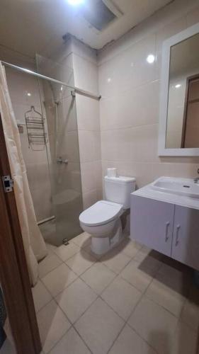 a bathroom with a toilet and a shower and a sink at Oowa's Residence in Jatirarangan