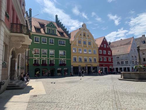 a group of colorful buildings on a street at Marktplatz Memmingen in Memmingen