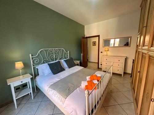 a bedroom with a bed with a green wall at LA CASA DEI FIORI - S. LORENZO in Rome