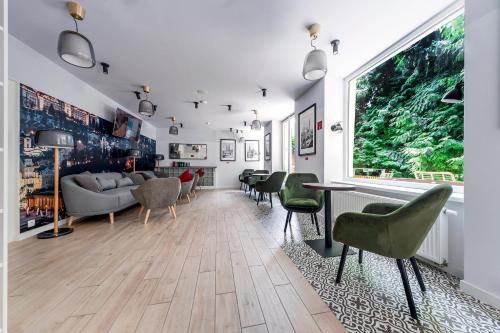 a living room with green chairs and a couch at Revelton Studios Prague in Prague
