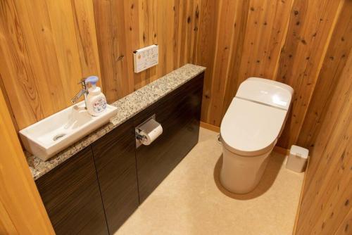 a bathroom with a toilet and a sink at Wind and horn Private villa with Mt tanigawa view in Komatsu