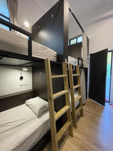 a bunk bed in a room with two bunk beds at Oceans Explore Hostel in Green Island