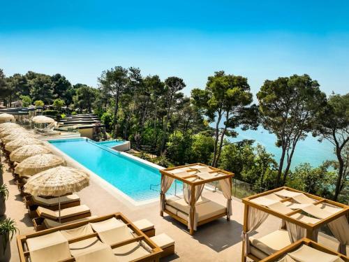 a resort with a swimming pool and lounge chairs at Camping Lanterna Premium Resort - Vacansoleil Maeva in Poreč