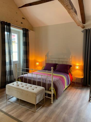 a bedroom with a bed and a bench and a window at Loft de charme en centre-ville in Pau