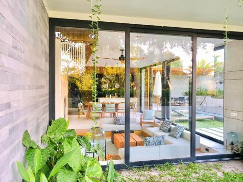 a patio with white couches and a table at 3 bedroom Villa with private pool on the west coast of Phu Quoc in Phu Quoc