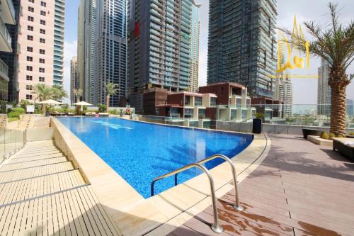 a swimming pool in a city with tall buildings at Panoramic Marina View 2BR Suite Damac Heights in Dubai