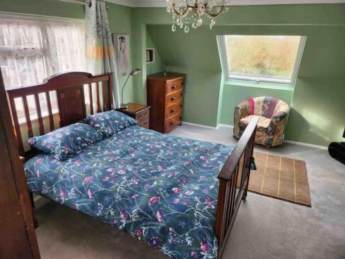 a bedroom with a bed and a chair and a window at Heath Farm cottage in Newport