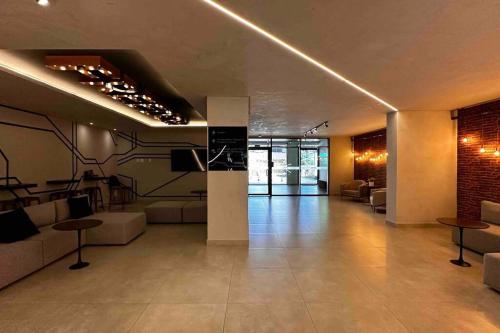 a living room with couches and tables in a building at Apartamento 2 quartos, St Bueno Parque Vaca Brava in Goiânia