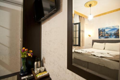 a hotel room with a bed and a mirror at Golden Horn Park Hotel in Istanbul