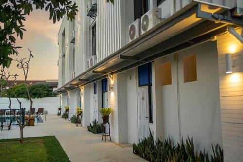 a side view of a building with a sidewalk at Singharaj Boutique Hotel in Chiang Mai