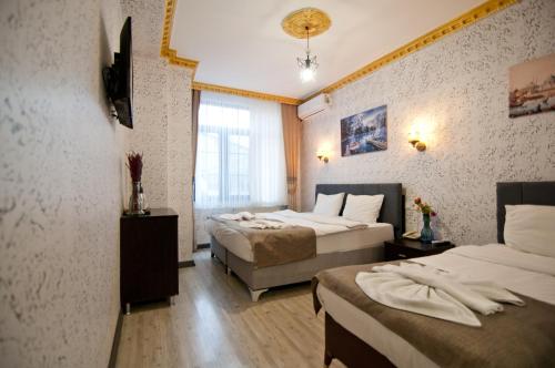 a hotel room with two beds and a window at Golden Horn Park Hotel in Istanbul