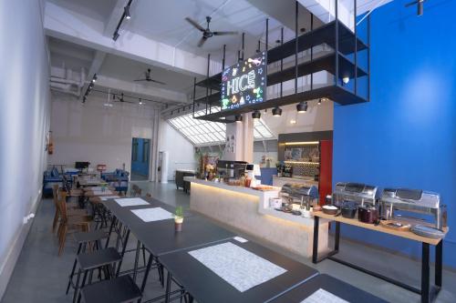 a restaurant with long tables and chairs and a counter at ARK HOTEL in Phnom Penh