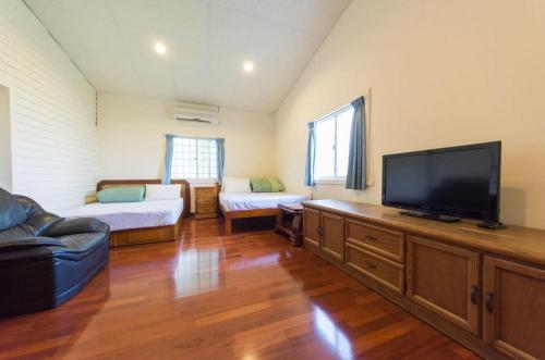 a large living room with a flat screen tv at Tap Bed & Breakfast in Taitung City