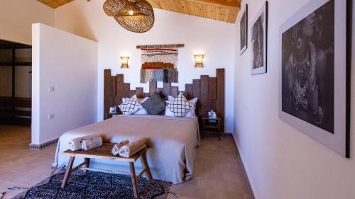 a bedroom with a large bed and a table at Dakhla Attitude in Dakhla
