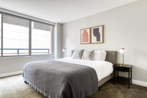 a white bedroom with a large bed and a window at Downtown 1br w pool gym roof nr Broad Museum LAX-1014 in Los Angeles